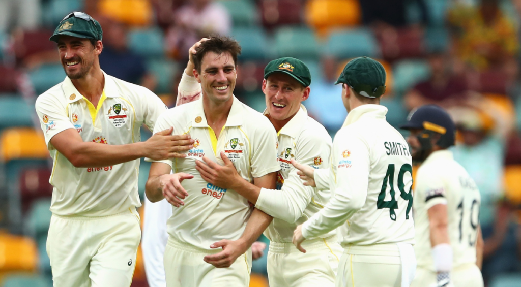 Australian captain Pat Cummins celebrates with team mates after dismissing Chris Woakes