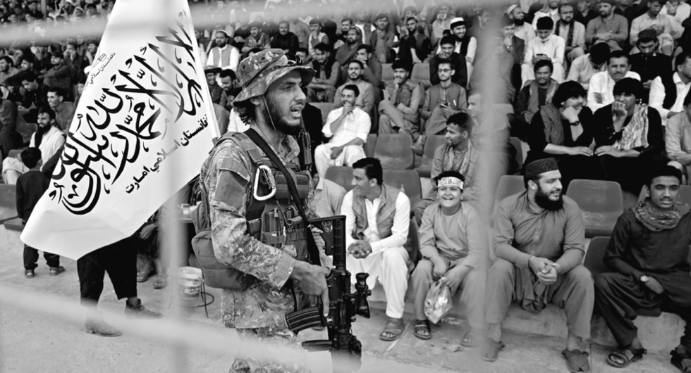 A Taliban fighter monitors a trial match at Kabul in September, ahead of the T20 World Cup, between Peace Defenders and Peace Heroes.