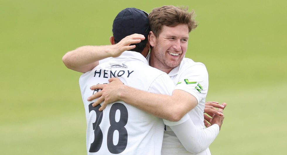 Liam Dawson embraces his Hampshire teammate Mohammad Abbas