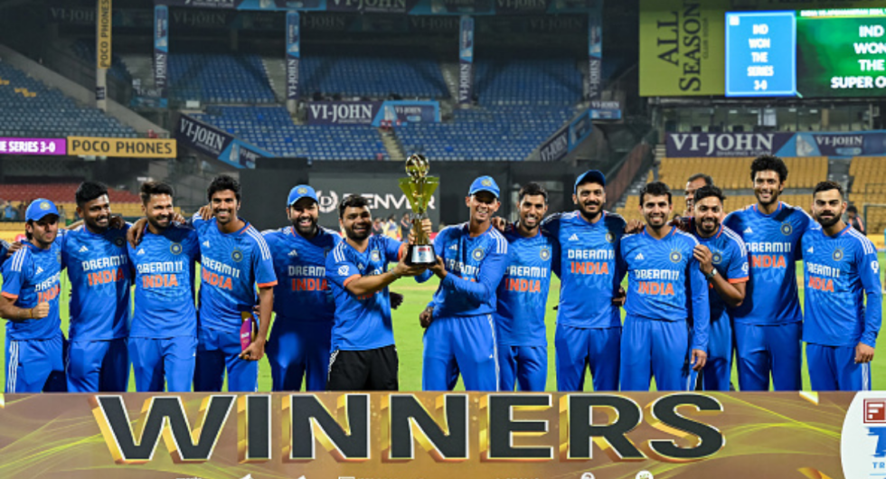 India's players pose with the series trophy after winning the second super over of third and final Twenty20 international cricket match between India and Afghanistan at the M. Chinnaswamy Stadium in Bengaluru on January 17, 2024.