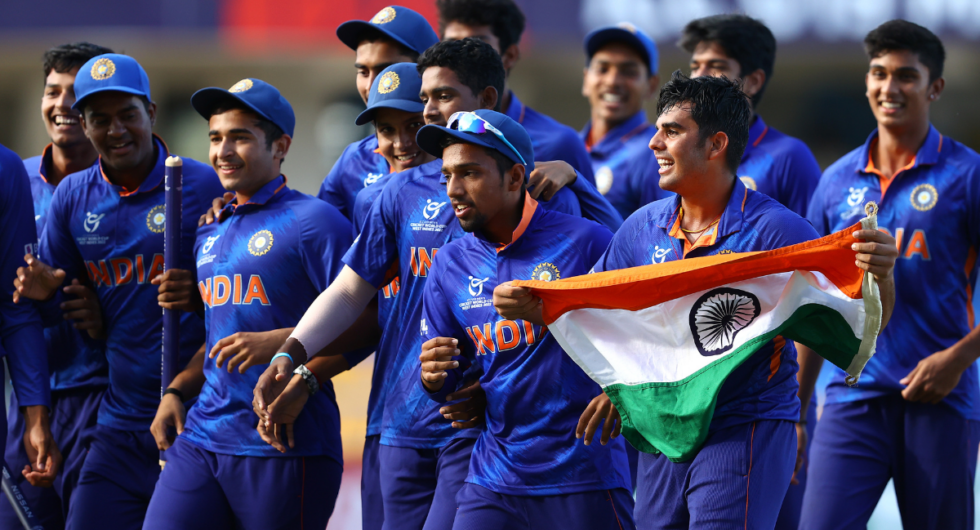 Nishant Siindhu of India holds the India flag as he leads the celebrations following his side's victory in the ICC U19 Men's Cricket World Cup Final match between England and India at Sir Vivian Richards Stadium on February 05, 2022 in Antigua, Antigua and Barbuda.