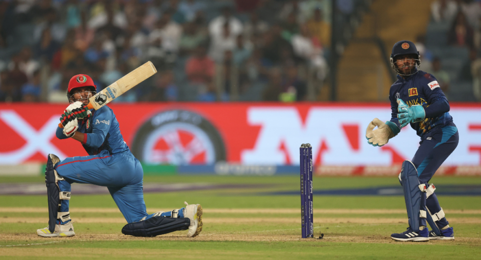 Azmatullah Omarzai of Afghanistan plays a shot as Kusal Mendis of Sri Lanka keeps during the ICC Men's Cricket World Cup India 2023 between Afghanistan and Sri Lanka at MCA International Stadium on October 30, 2023 in Pune, India.