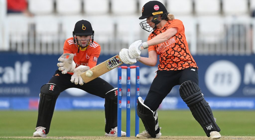 Emily Windsor of Southern Vipers hits out watched by Sarah Bryce during the Rachael Heyhoe Flint Trophy Final 2023