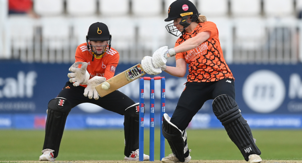 Emily Windsor of Southern Vipers hits out watched by Sarah Bryce during the Rachael Heyhoe Flint Trophy Final 2023