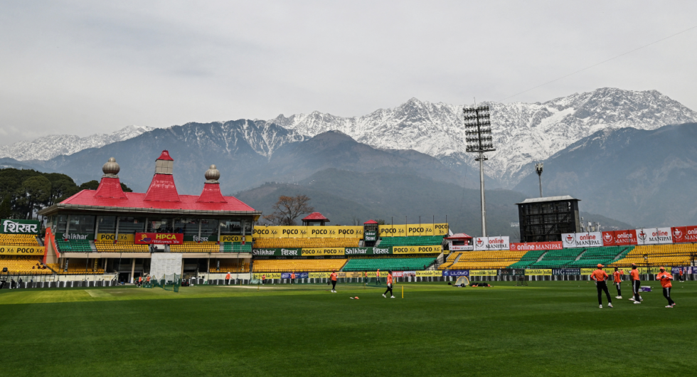 A general view of the Himachal Pradesh Cricket Association Stadium shows India's players attending a practice session, ahead of the fifth and final Test cricket match between India and England, in Dharamsala on March 5, 2024.