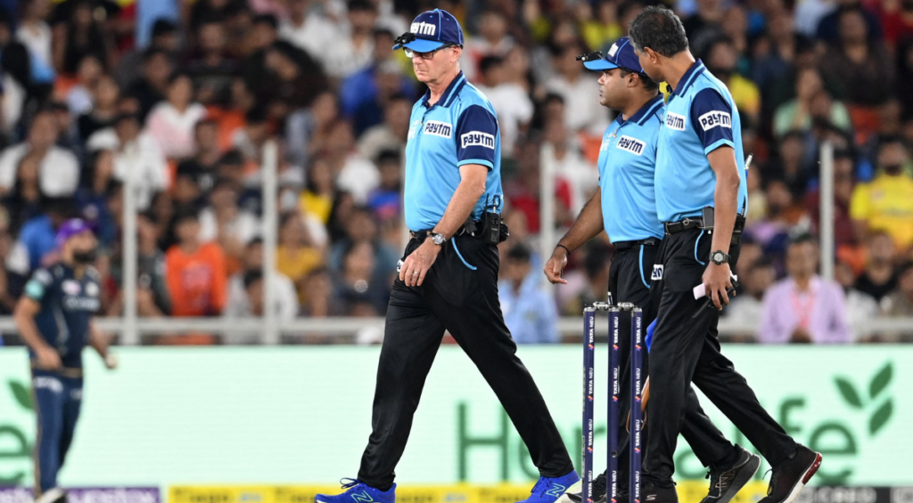 Match umpires inspect the ground after rainfall during the Indian Premier League (IPL) Twenty20 final cricket match between Gujarat Titans and Chennai Super Kings at the Narendra Modi Stadium in Ahmedabad on May 29, 2023.