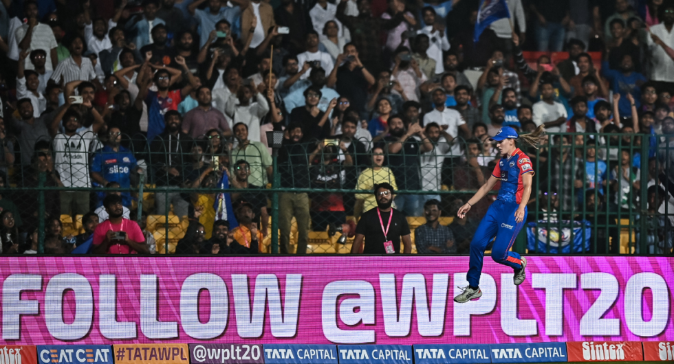 Delhi Capitals' Annabel Sutherland jumps to field the ball during the 2024 Women's Premier League (WPL) match between Mumbai Indians and Delhi Capitals at the M. Chinnaswamy Stadium in Bengaluru on February 23, 2024.