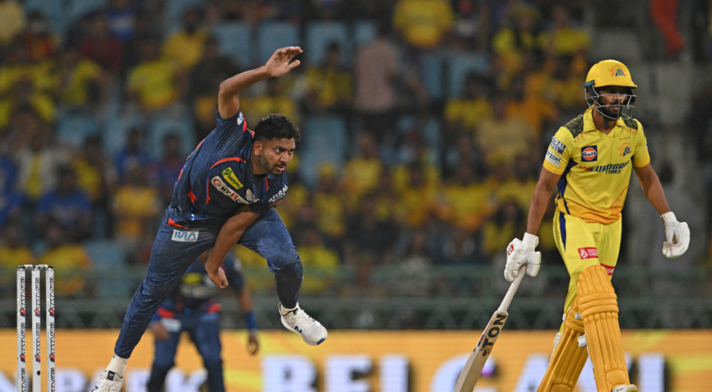 Lucknow Super Giants' Mohsin Khan (L) bowls as Chennai Super Kings' captain Ruturaj Gaikwad looks on during the Indian Premier League (IPL) Twenty20 cricket match between Lucknow Super Giants and Chennai Super Kings at the Ekana Cricket Stadium in Lucknow on April 19, 2024.