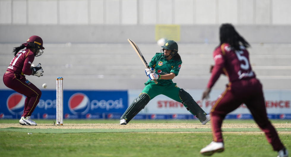 Pakistani cricketer Sana Mir (C) moves as West Indies wicketkeeper Merissa Aguilleira (L) drops a catch during the first Twenty20 (T20) match between Pakistan and West Indies' women cricket teams at the Southend Club Cricket Stadium in Karachi on January 31, 2019