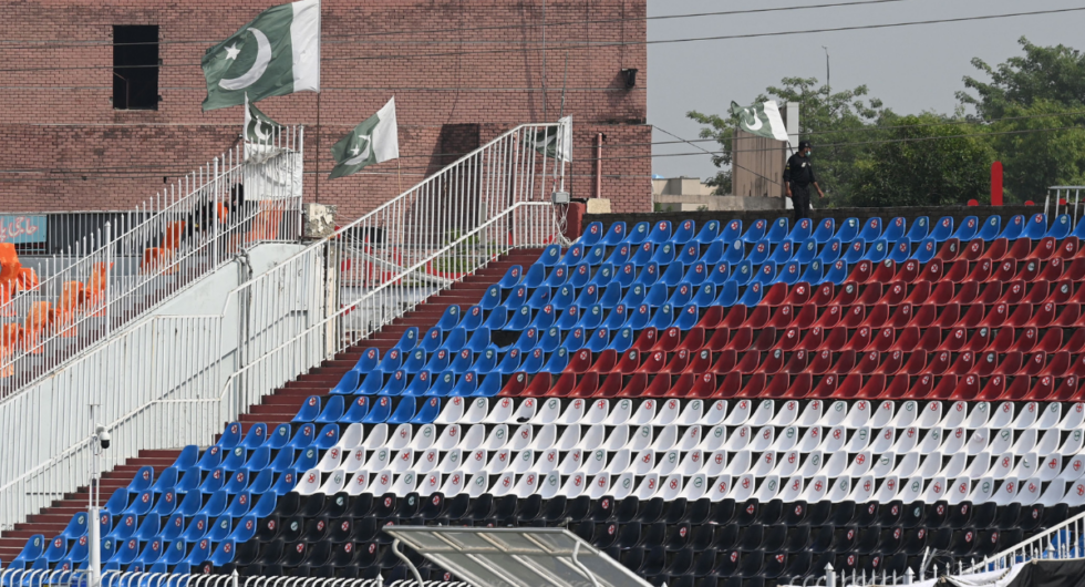 A policeman stands guard on the empty stands of the Rawalpindi Cricket Stadium in Rawalpindi on September 17, 2021, after New Zealand postponed a series of one-day international (ODI) cricket matches against Pakistan over security concerns.