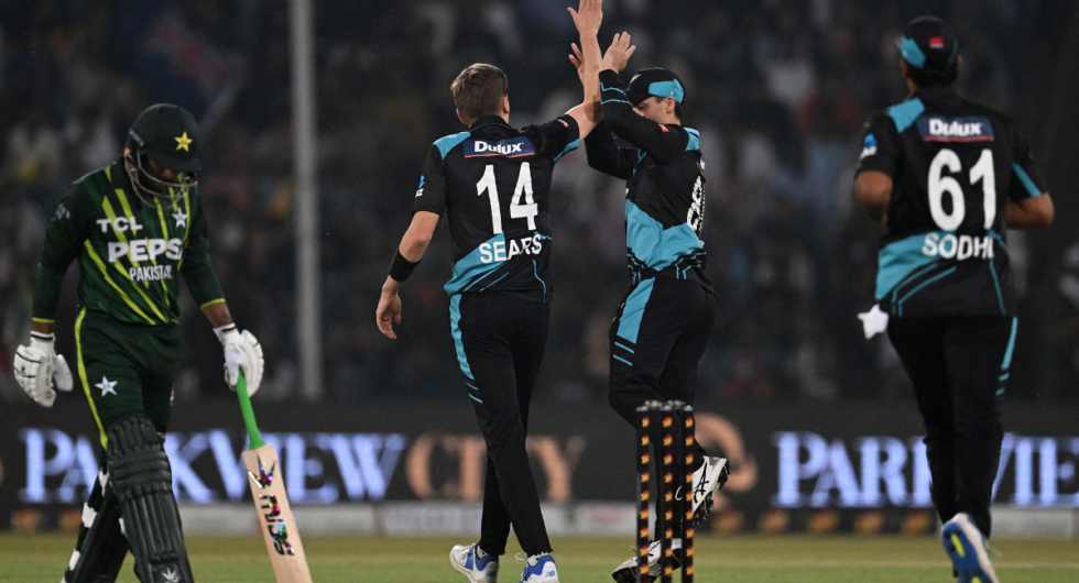 New Zealand's cricketers (C) celebrate after dismisssal of Pakistan's Usman Khan (L) during the fourth Twenty20 international cricket match between Pakistan and New Zealand at the Gaddafi Cricket Stadium in Lahore on April 25, 2024.