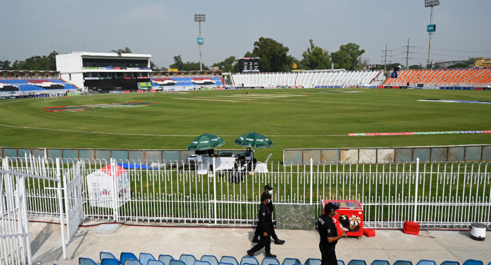 Pakistani policemen walk near the empty stands od the Rawalpindi Cricket Stadium in Rawalpindi on September 17, 2021, after New Zealand postponed a series of one-day international (ODI) cricket matches against Pakistan over security concerns.
