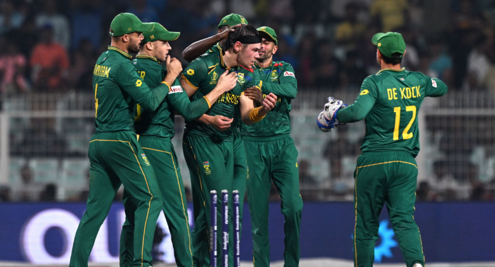 South Africa's Gerald Coetzee (C) celebrates with teammates after taking the wicket of Australia's Josh Inglis during the 2023 ICC Men's Cricket World Cup one-day international (ODI) second semi-final match between Australia and South Africa at the Eden Gardens in Kolkata on November 16, 2023.