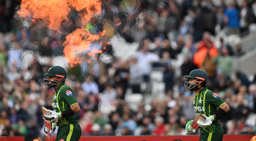 Babar Azam and Mohammad Rizwan walk out to open the batting for Pakistan