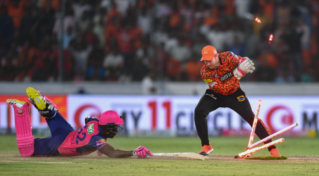 Sunrisers Hyderabad's Heinrich Klaasen attempts to run out Rajasthan Royals' Rovman Powell (L) during the Indian Premier League (IPL) Twenty20 cricket match between Sunrisers Hyderabad and Rajasthan Royals at the Rajiv Gandhi International Stadium in Hyderabad on May 2, 2024.